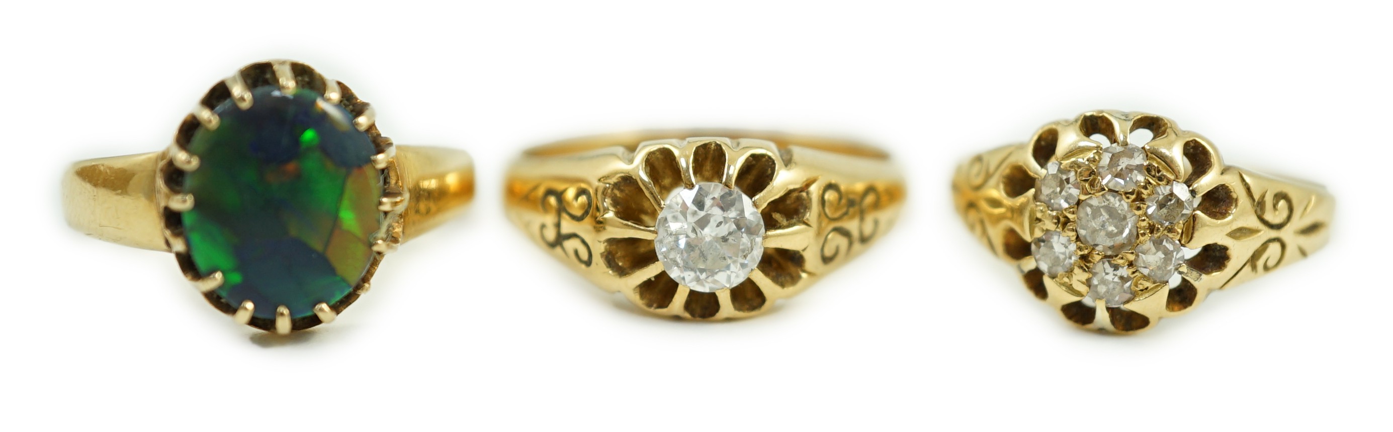 An early 20th century 18ct gold and diamond cluster ring, size P/Q, gross weight 3.1 grams and two other yellow metal rings including claw set solitaire diamond ring, size Q, gross weight 9.1 grams(2).